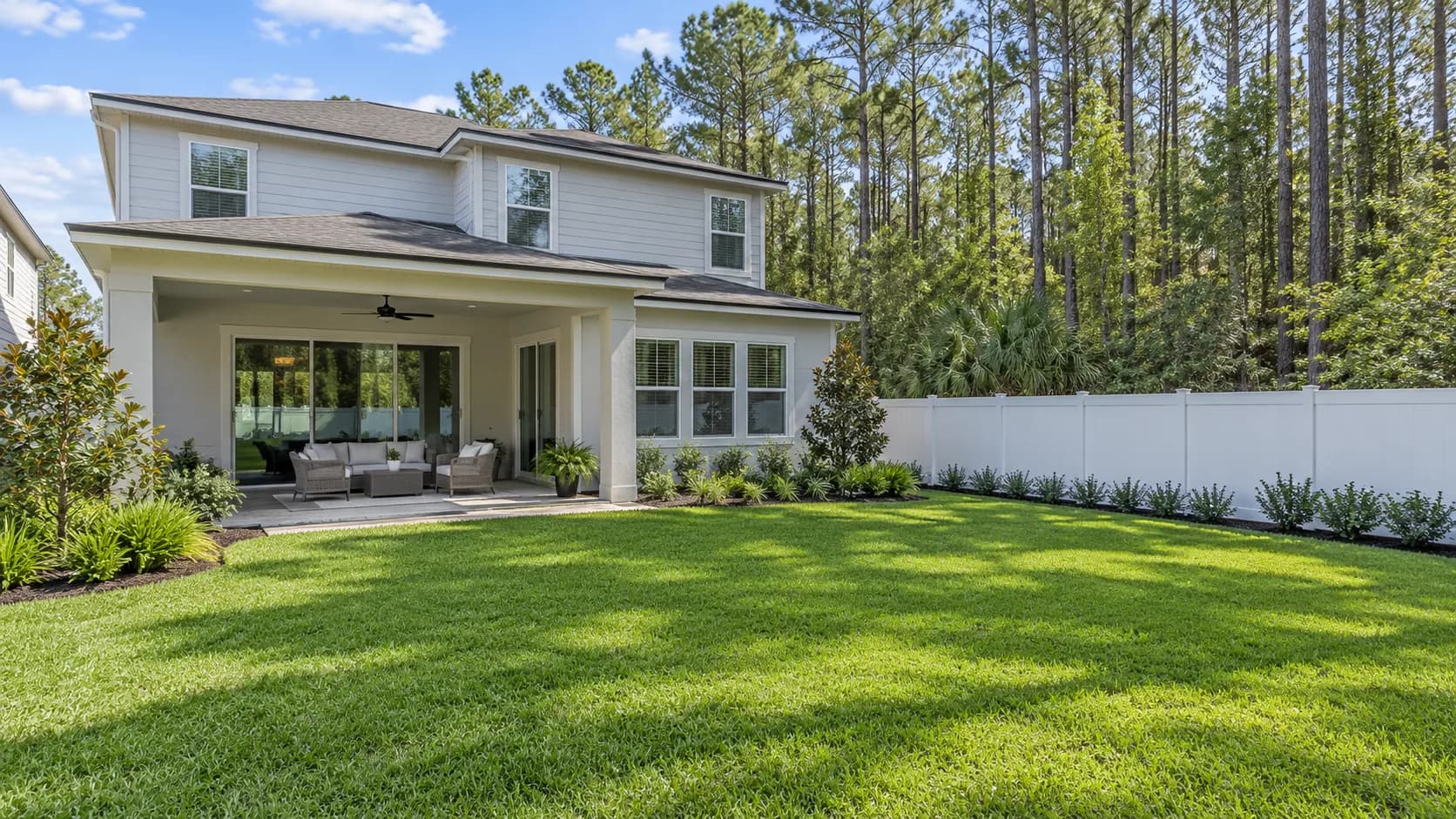 Newer two-story home in Nocatee with a fenced backyard backing up to pine woods