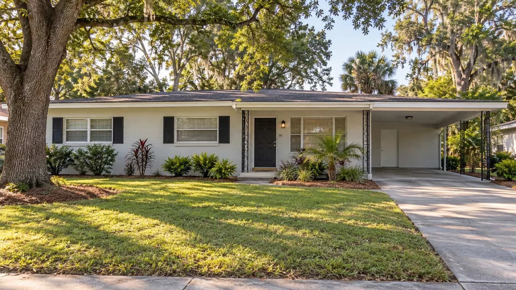 Single-story concrete block ranch home with a carport on a quiet street in Cedar Hills, Jacksonville
